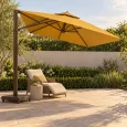 Dù lệch tâm vuông màu vàng đất nghiêng về bên phải, trụ bên trái thẳng đứng cạnh ghế đọc sách