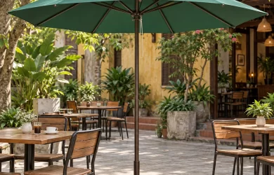 Minh họa ô chính tâm tán xanh với trụ giữa và đế tròn trong sân cafe