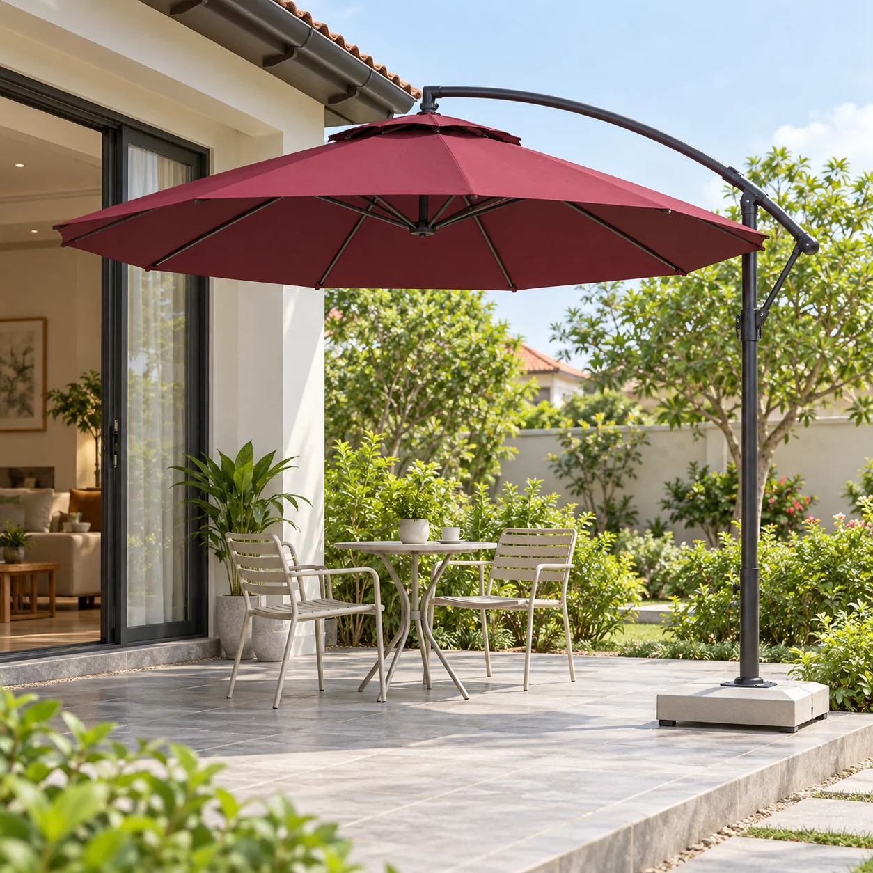 Ô lệch tâm tròn màu đỏ rượu có tay đỡ cong và trụ bên phải cạnh cụm ghế trước hiên